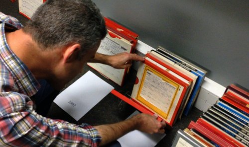 Man sorting through deposited Wellington Access Radio material.