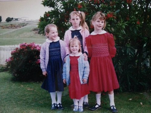 Group of children in matching dresses in the eighties.