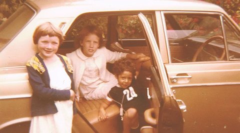 Image of three children and a car in the eighties.