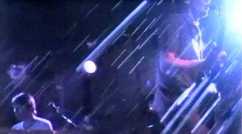 A blurry image of a band gig