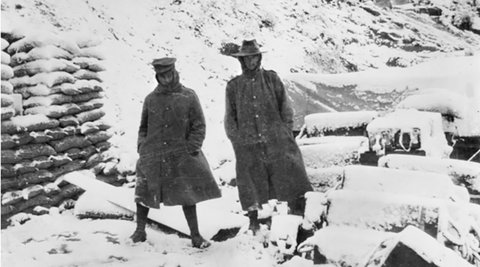 Two Australian soldiers standing in the snow outside a dugout on the Gallipoli Peninsula in WWI.