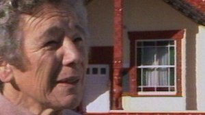 Image of Dorothy Huhana Mihinui in front of a marae.