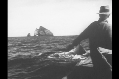 Herbert Cook in the whaleboat off Piercy Island.