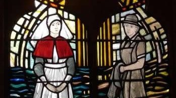 A stained glass window depicting two nurses
