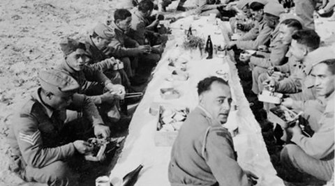 Members of the 28 (Māori) Battalion Eating Christmas Dinner in the desert.