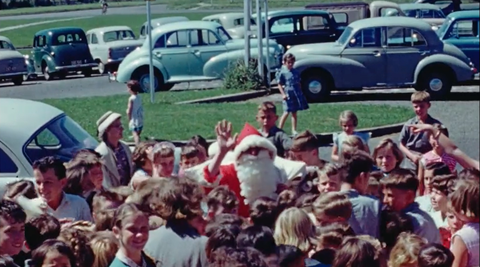 Still from a video filmed in 1955 in Naenae of crowds greeting Santa Claus.