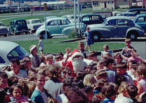 Still from a video filmed in 1955 in Naenae of crowds greeting Santa Claus.