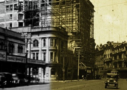 A building under construction. One half of the image is in black and white and the other has a sepia tone.