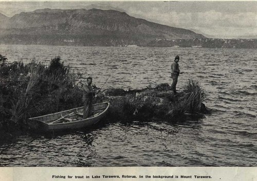 Two men fishing on a lakeside.