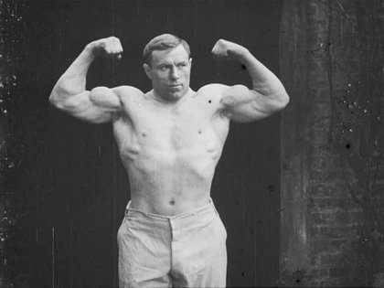 Wrestler in shorts poses for camera