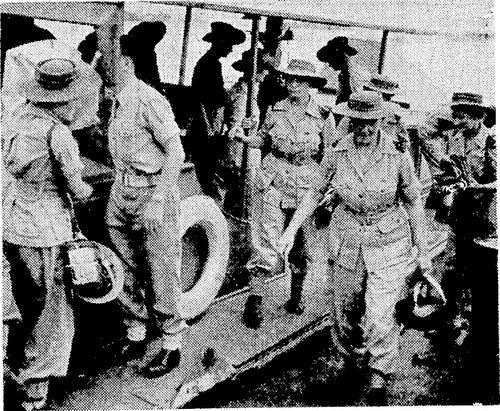 A grainy image of female nurses coming off a boat in uniform.