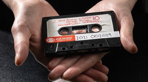 Image of person holding cassette tape.