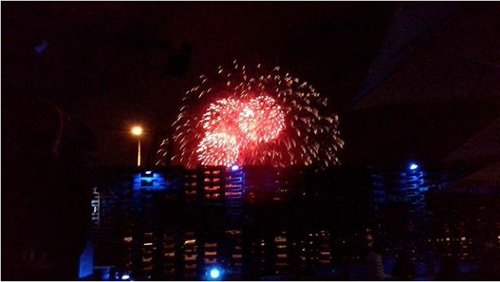 Red fireworks are in the night sky above the Pallet Pavillion.