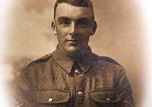 A portrait of a young male soldier in sepia tones.