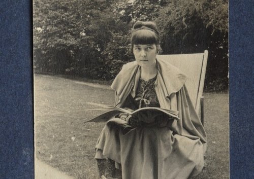 Woman sitting with a book.