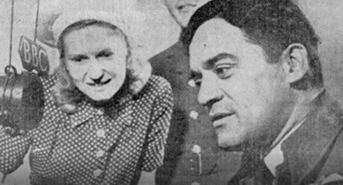 Image of Kingi Tahiwi and a woman watching him broadcasting to New Zealand from London during World War II.