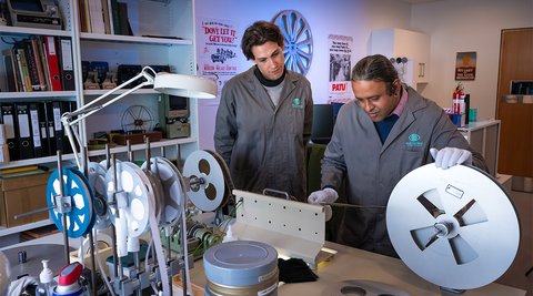 two models at film table winding through film, Our Preservation cover image