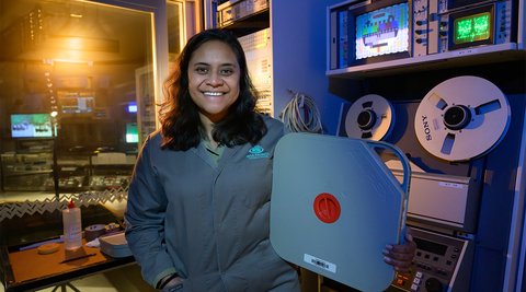 model inside preservation area holding taonga smiling, Who are we cover image