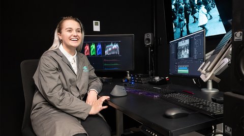 female model in film digital preservation room smiling, Work for us cover image