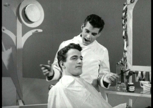 Still from a Loxene Advert, with a barber and client.
