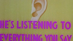 Still from Len Lye film 'Musical Poster No.1' - Hand drawn ear on a yellow background with pink writing saying' He's Listening To Everything You Say'.