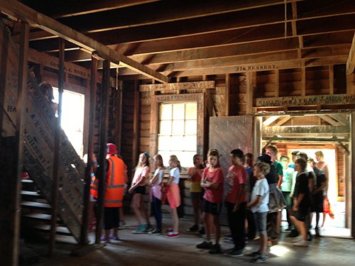 A group of school children arriving inside the woolshed for the screening.