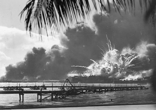 An explosion on a beach during the attack on Pearl Harbour.