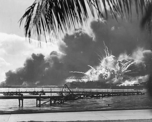 An explosion on a beach during the attack on Pearl Harbour