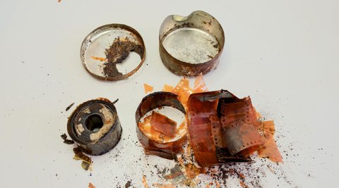 Old rusty film canisters and damaged film.