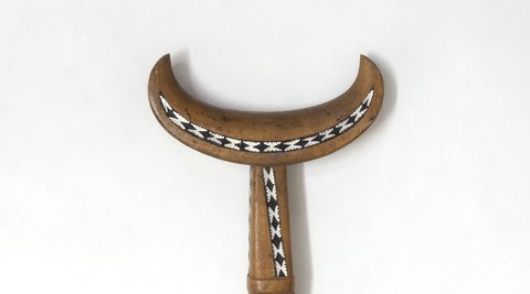Decorated handle of a wooden paddle from the Solomon Islands.