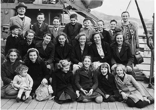 Black and white photo of a group of children on a ship.