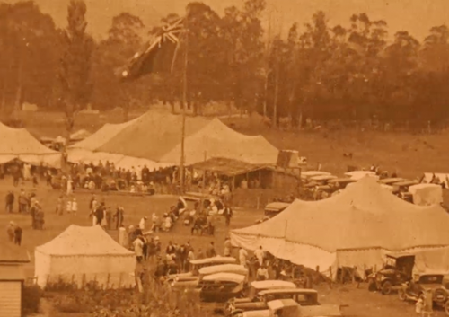 Tents and people viewed from above.