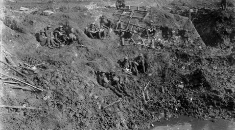 New Zealand engineers resting in a large shell crater at Spree Farm following the First Battle of Passchendaele.