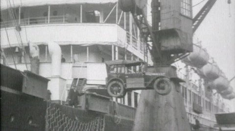 Image of vehicle being loaded onto a boat.