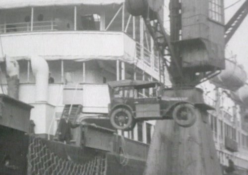 Image of vehicle being loaded onto a boat.