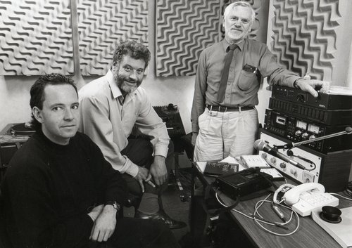 Men in sound broadcasting studio.