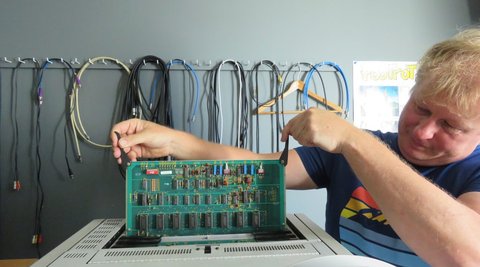 Adam Sondej holding the delicate circuitry inside the AMPEX VPR-80.