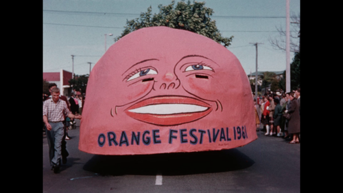 Still from a film by Tauranga amateur filmmaker Norman Blackie - Giant Orange Float in a parade for the Orange Festival 1961.