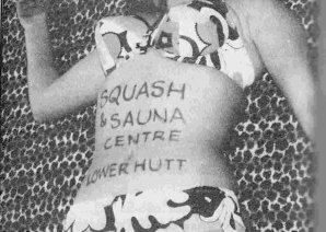 Woman in a bikini with the writing 'Squash & Sauna Centre, Lower Hutt, on her stomach.