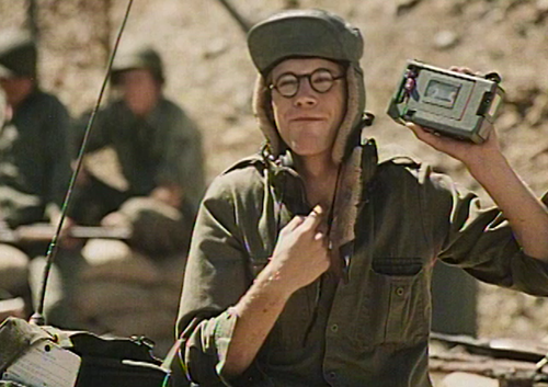Soldier holding tape player.