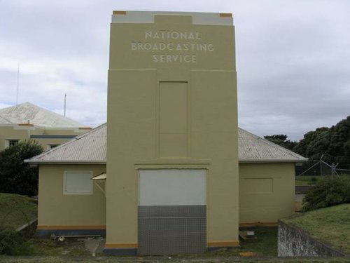 A concrete transmitter building with the words 'National Broadcasting Service' carved into the concrete.