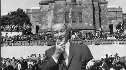 US President Lyndon Johnson is speaking into a microphone at the National War Memorial in Wellington.