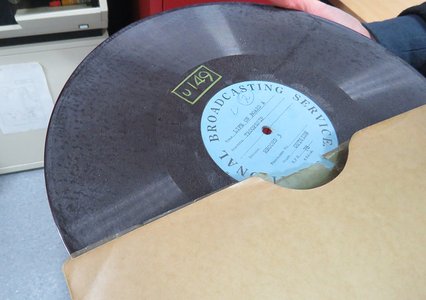 A record from the 1940s being removed from its paper sleeve.