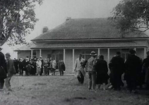 Still from 'Reflecting on Waitangi' - Groups of people standing outside at Waitangi in 1934.