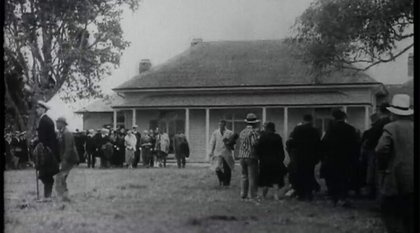 Still from 'Reflecting on Waitangi' - Groups of people standing outside at Waitangi in 1934.