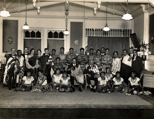 Performers from “Pageant of Māori History” posing for a photo on stage.