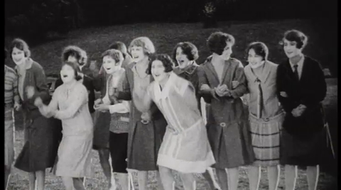 Screengrab from the 1927 film, 'Who’s for Hollywood, Series 2' - group of women standing on the grass.
