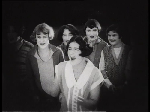 Screengrab from the 1927 film, 'Who’s for Hollywood, Series 2' - group of women cheer on their team.
