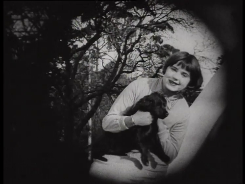 Freda Crosher plays with a dog