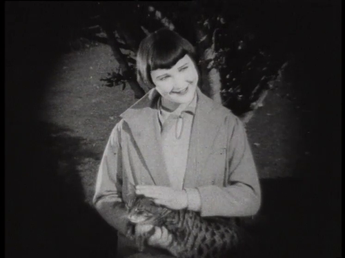 Freda Crosher plays with a cat
